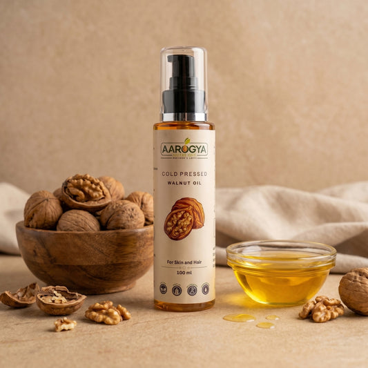 Pure cold pressed walnut oil bottle for hair growth and skin glowing care, placed alongside whole shelled walnuts.