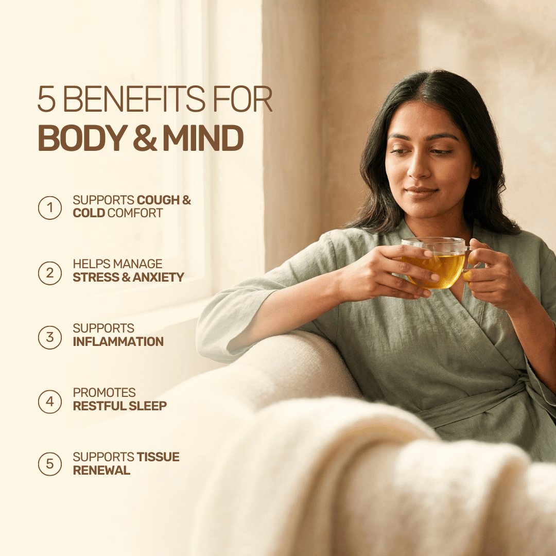A serene woman cradling a warm glass mug of Aarogya herbal tea on a couch, illustrating 5 benefits for body and mind.