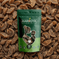 Aarogya Nutri Mix natural dried amla candy green pouch on a textured background of sun-dried gooseberry pieces.