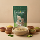 Bowl of warm multigrain porridge topped with nuts, served next to Aarogya Nutri Mix pouch and bowls of raw seeds