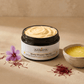 A white and black container of Aarogya Shata Dhauta Ghrita, a 100 times washed pure A2 ghee cream with saffron.