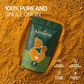 Aarogya single origin turmeric powder pouch resting in a textured bed of pure, deep golden-yellow ground turmeric