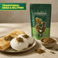Aarogya Idli Podi pouch next to a plate of fresh idlis and dosa sprinkled with savory spice powder.