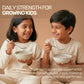 Two happy children eating healthy, nutrient-rich Aarogya black rice porridge for daily strength.
