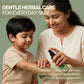 Mother applying Aarogya Kuppintaku Oil to a child's arm, providing gentle herbal care for family skin and scalp needs.