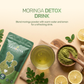 A glass of moringa detox drink with lemon slices and text on blending powder with warm water for a refreshing drink.