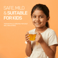 A smiling young girl holding a cup of safe, mild, and kid-friendly immunity boosting tulsi blend tea.